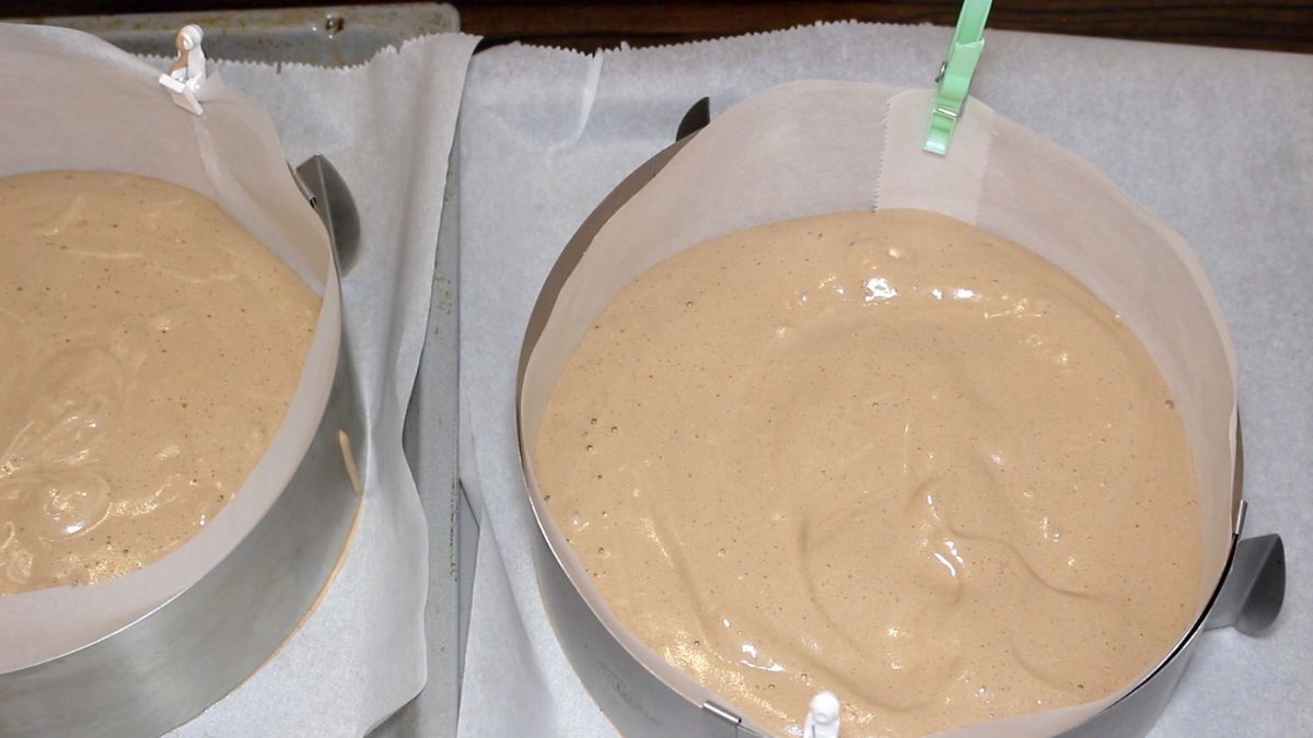 Two bowls of cake base on a baking sheet.