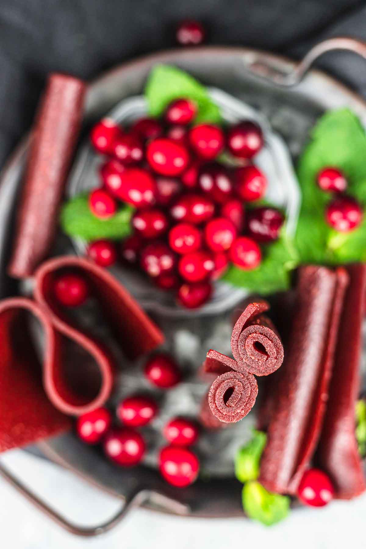 A plate of cranberries and cranberry leather.