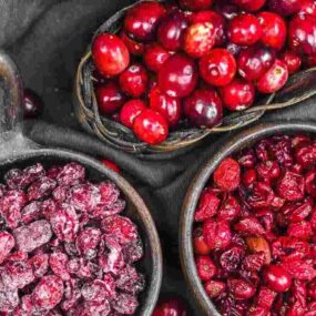 Cranberries in bowls on a table.