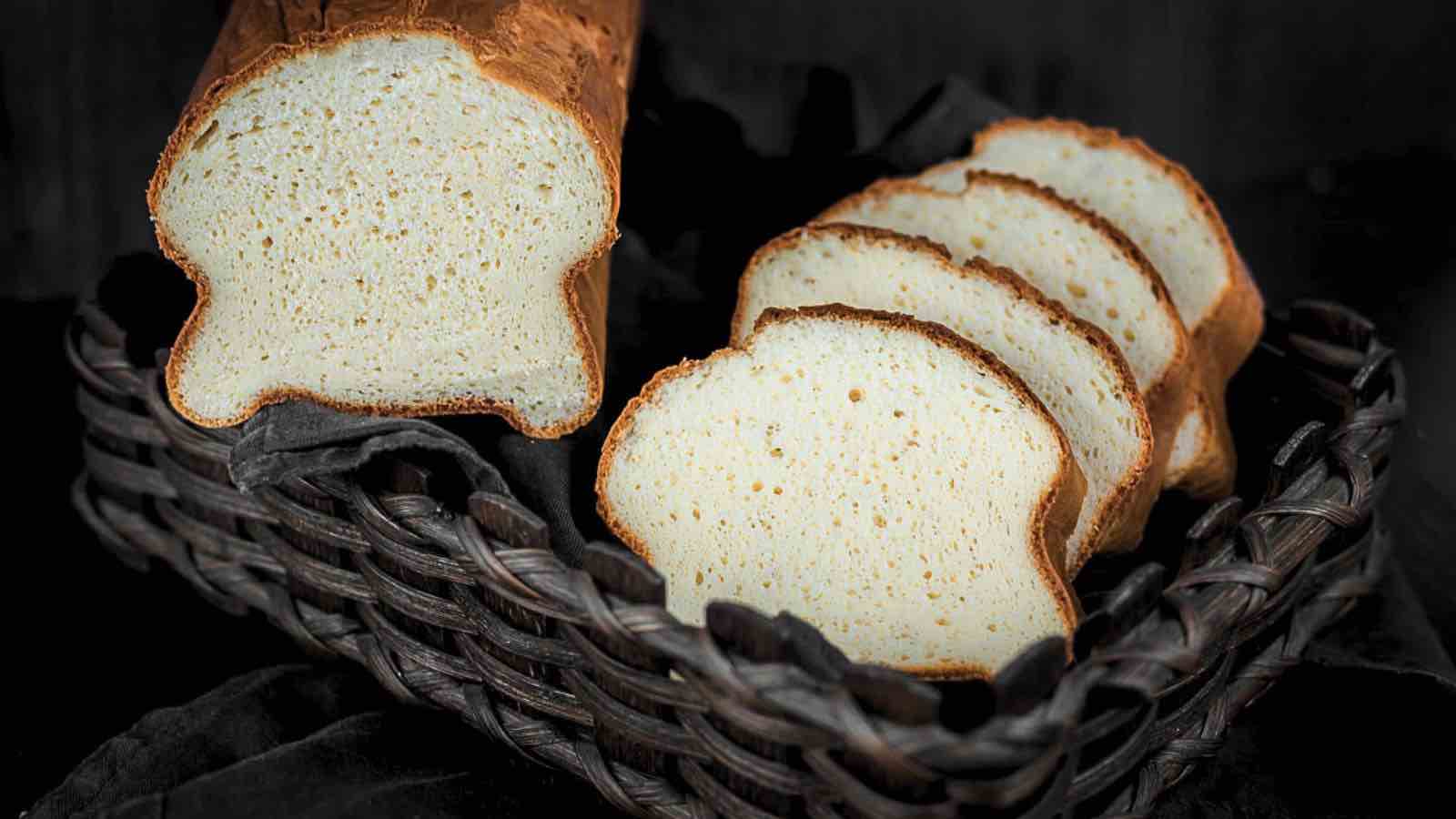 Two slices of bread in a basket on a black background.