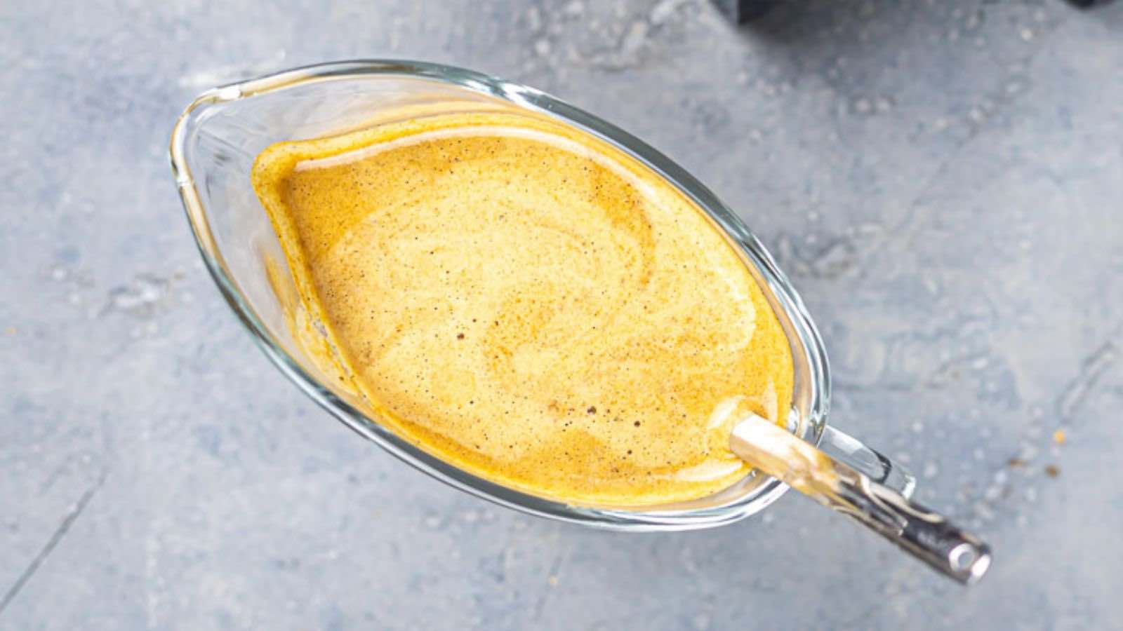 A glass bowl with a Worcestershire sauce in it.