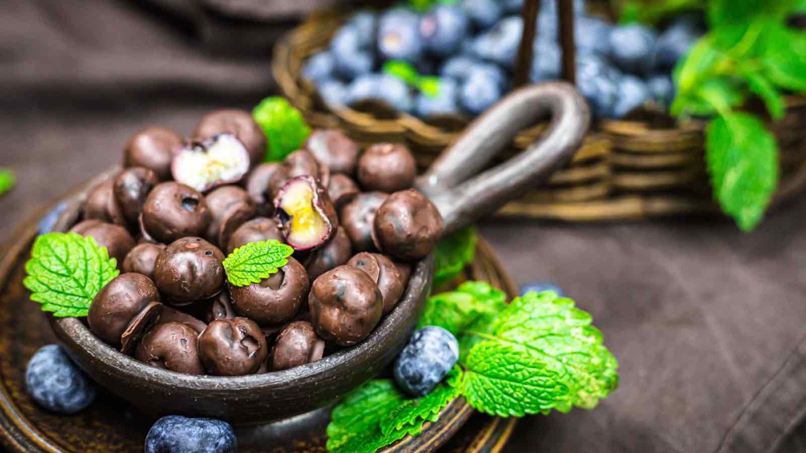 Chocolate covered blueberries in a bowl.