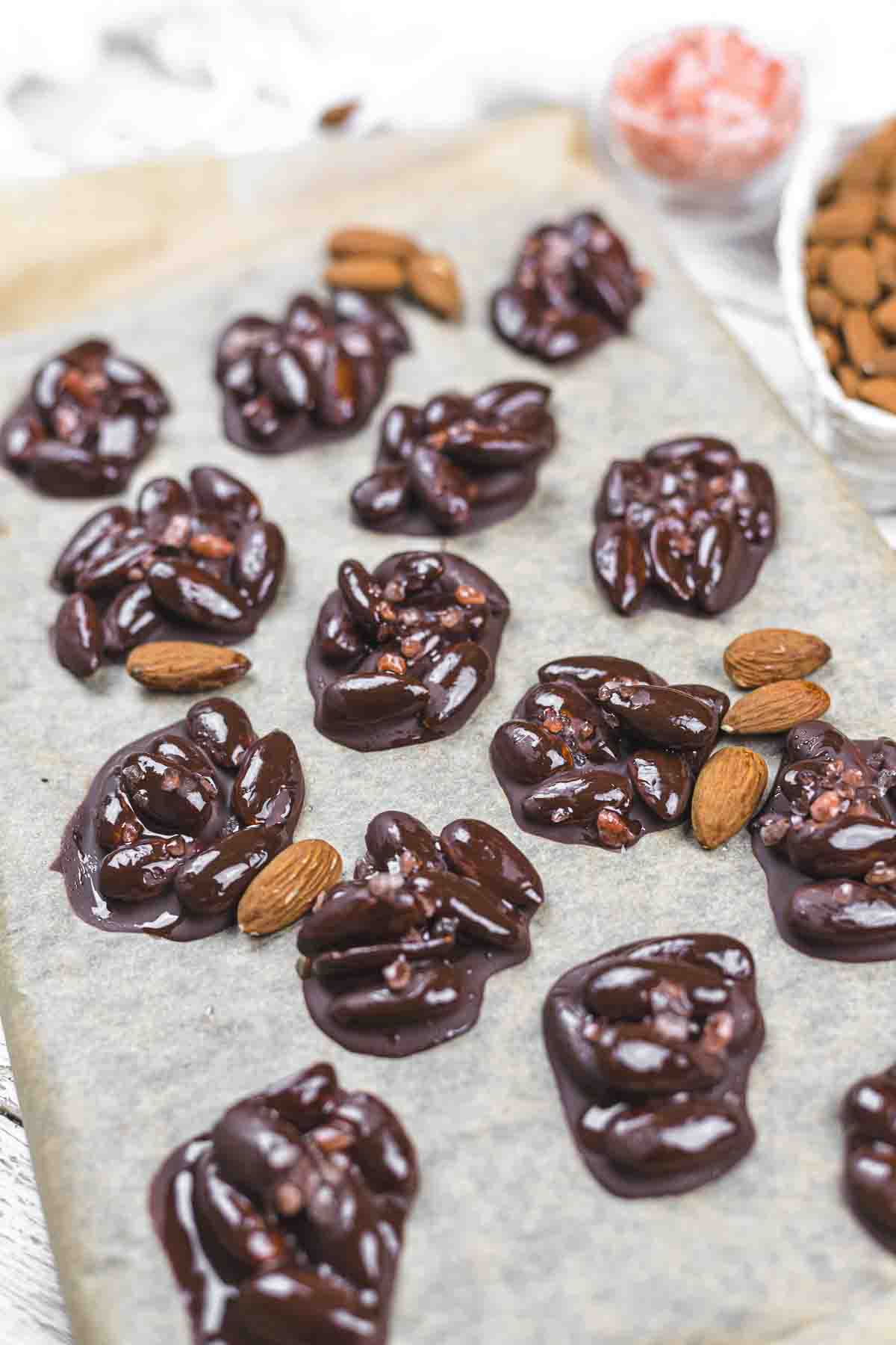 Chocolate covered almonds on a baking sheet.