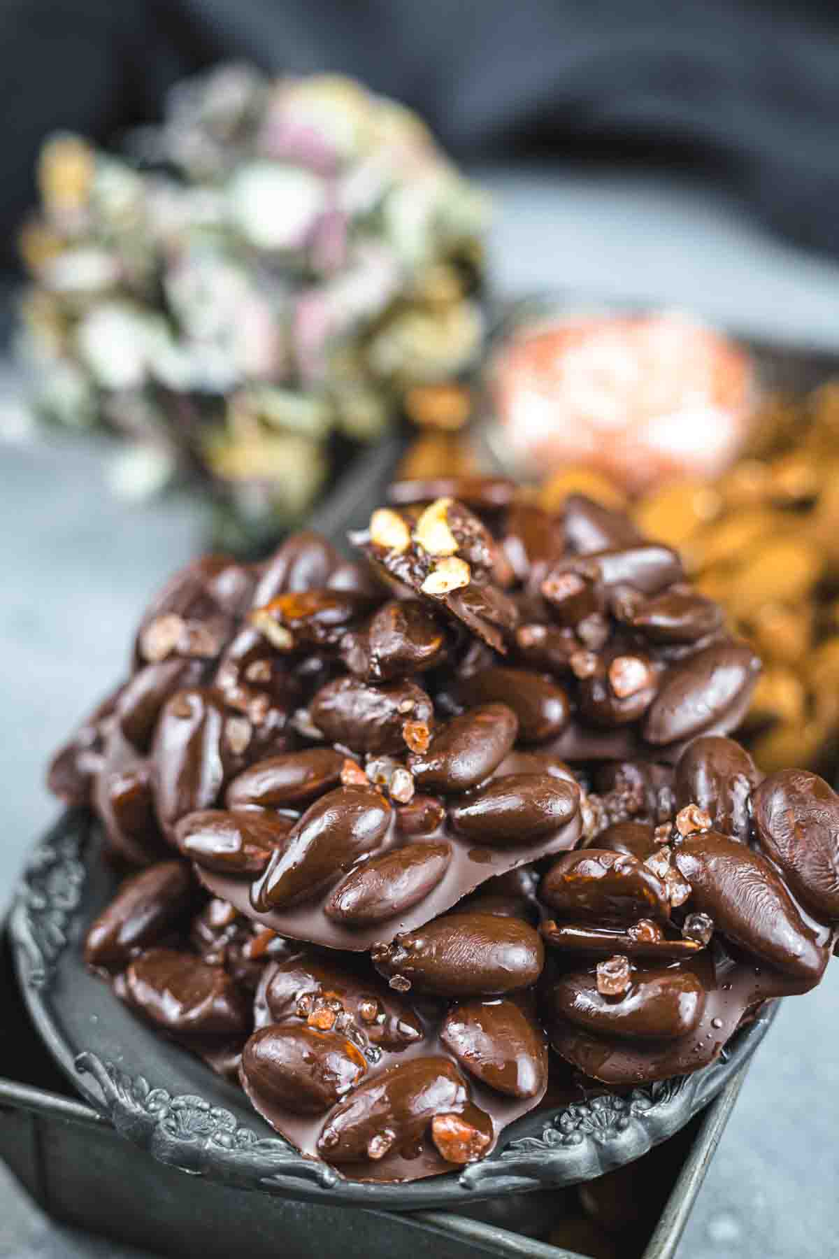 Chocolate covered almonds on a plate.