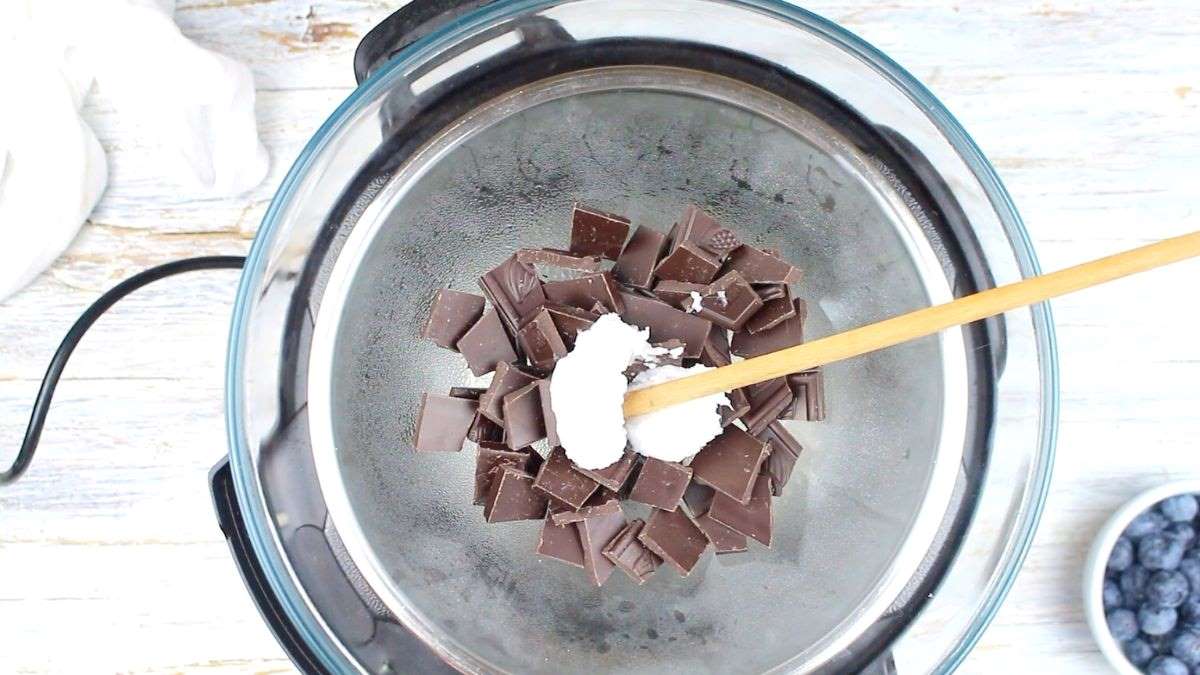 Melting chocolate and coconut oil in a bowl.