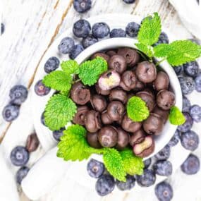 Chocolate and blueberries in a cup.