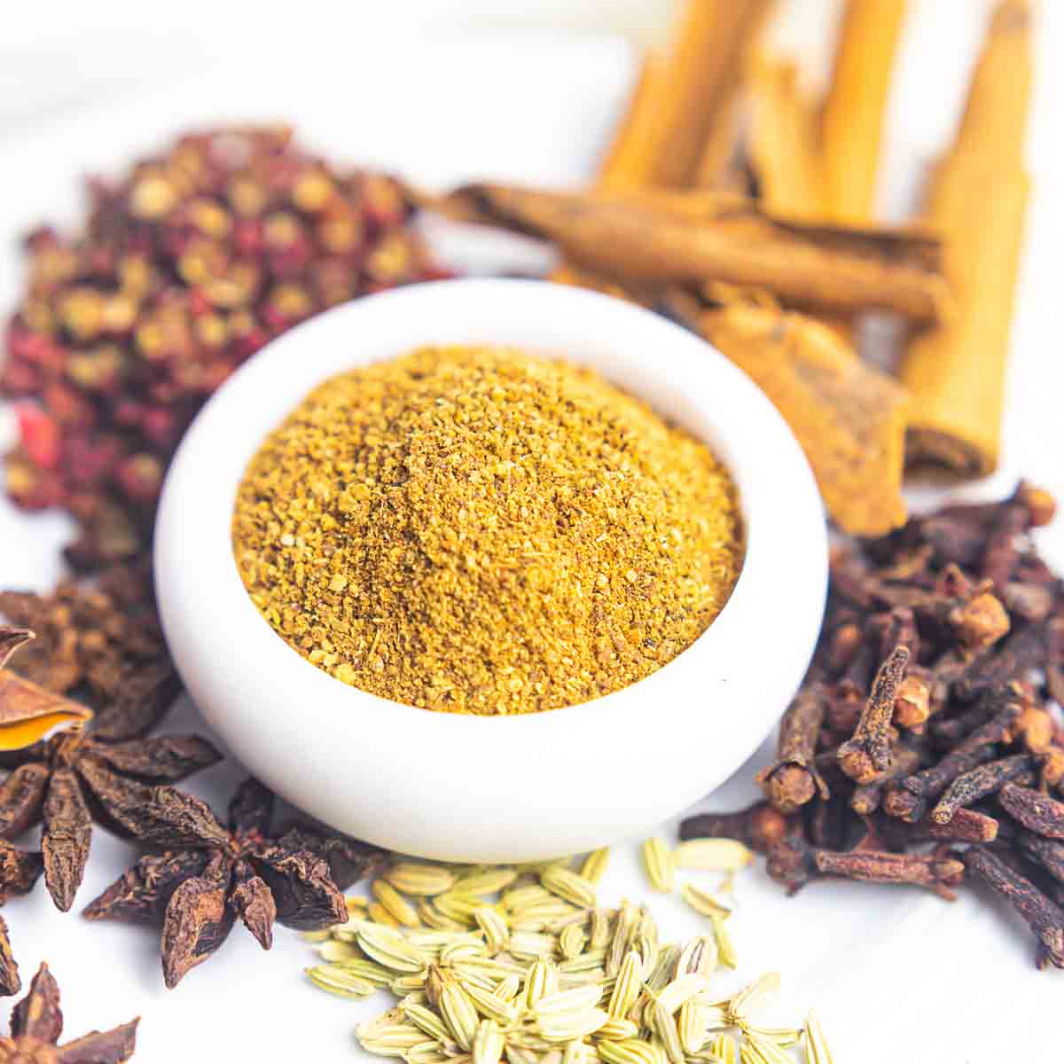 A bowl of spices and herbs on a white plate.