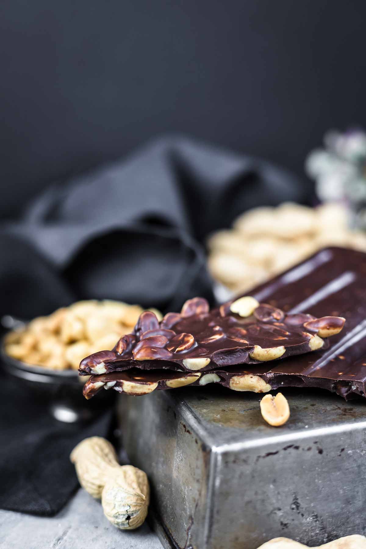 A close-up of dark chocolate bark with nuts.
