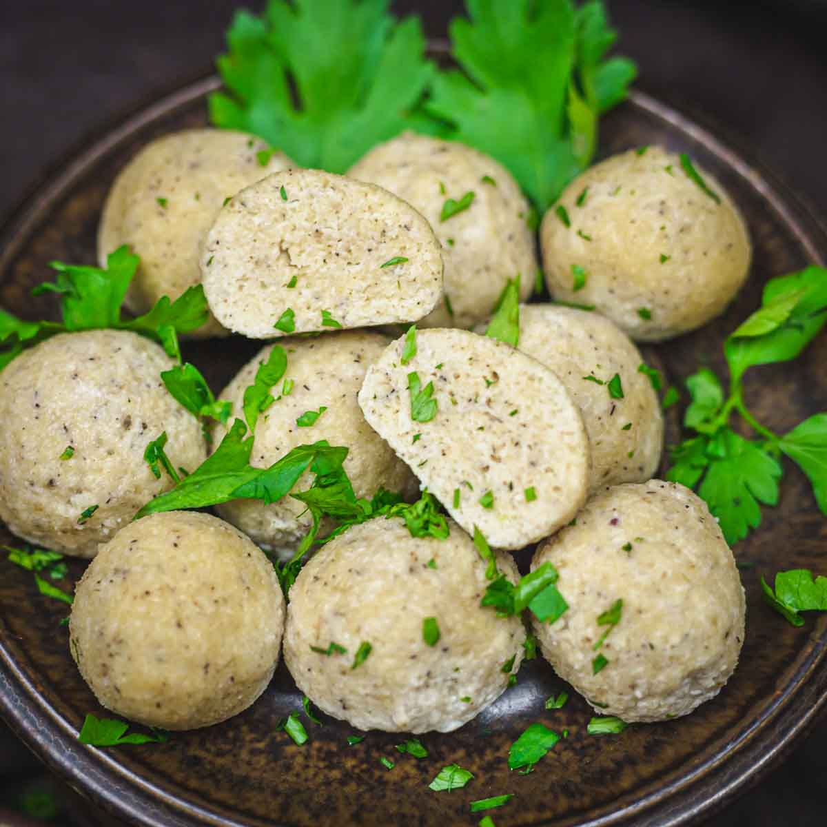 A plate of keto dumplings balls garnished with fresh parsley.