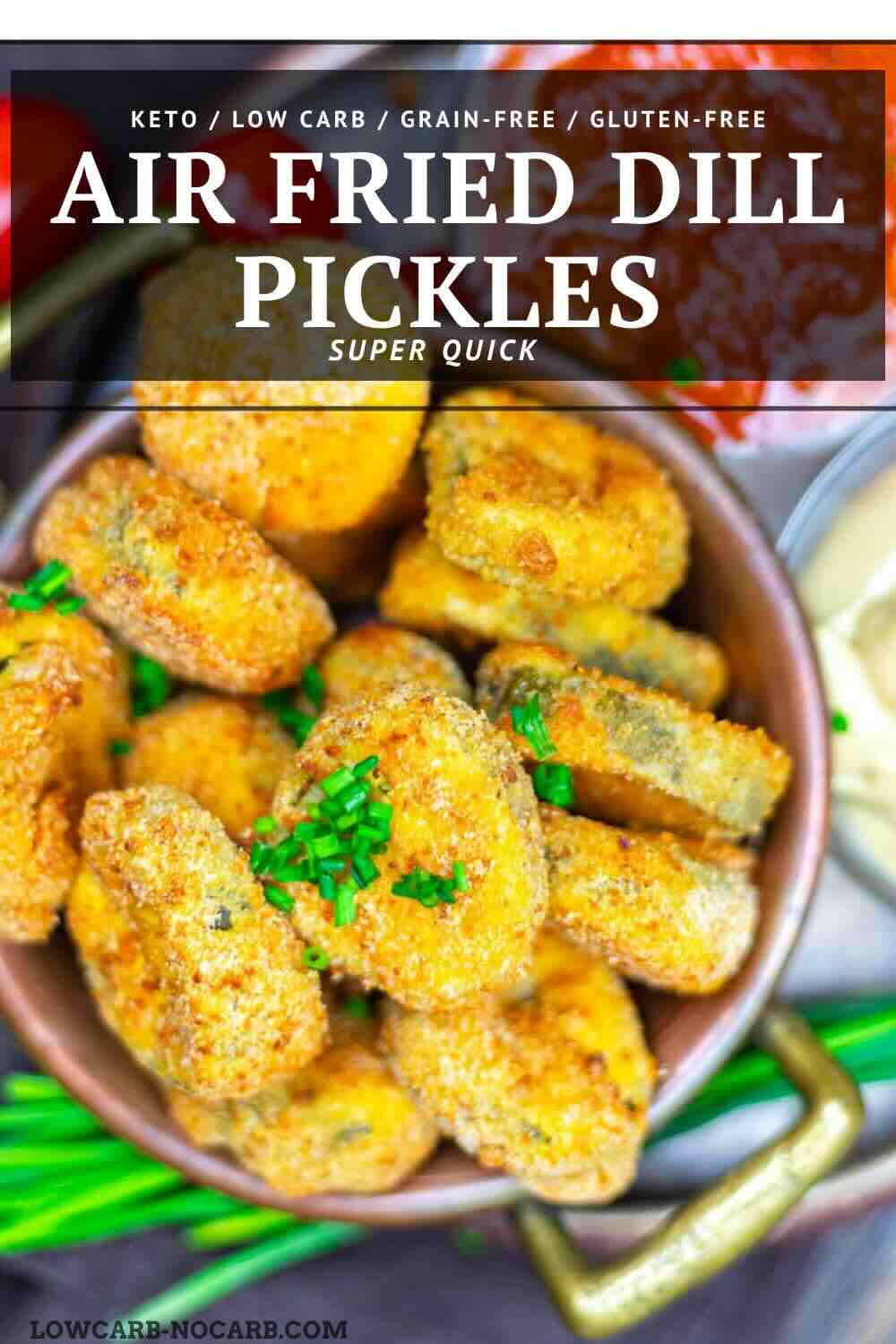 A bowl of air fried dill pickle slices garnished with chopped chives, with a dip and green onions in the background.
