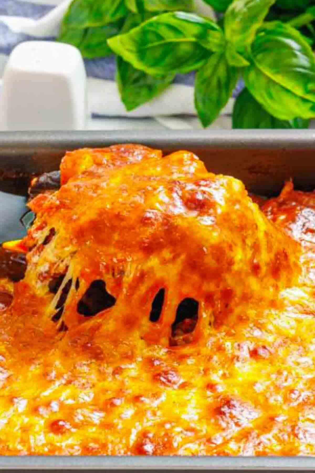 Closeup of melted cheese over eggplant casserole.