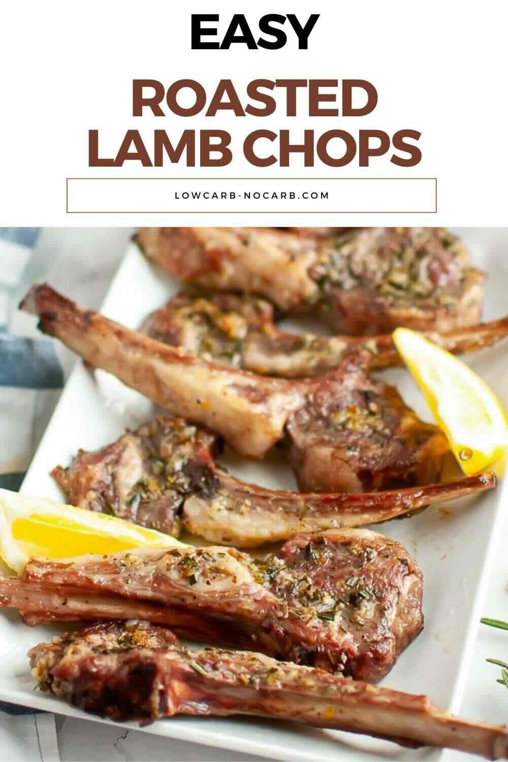 A plate of roasted lamb chops garnished with herbs and served with lemon wedges on a white rectangular dish.