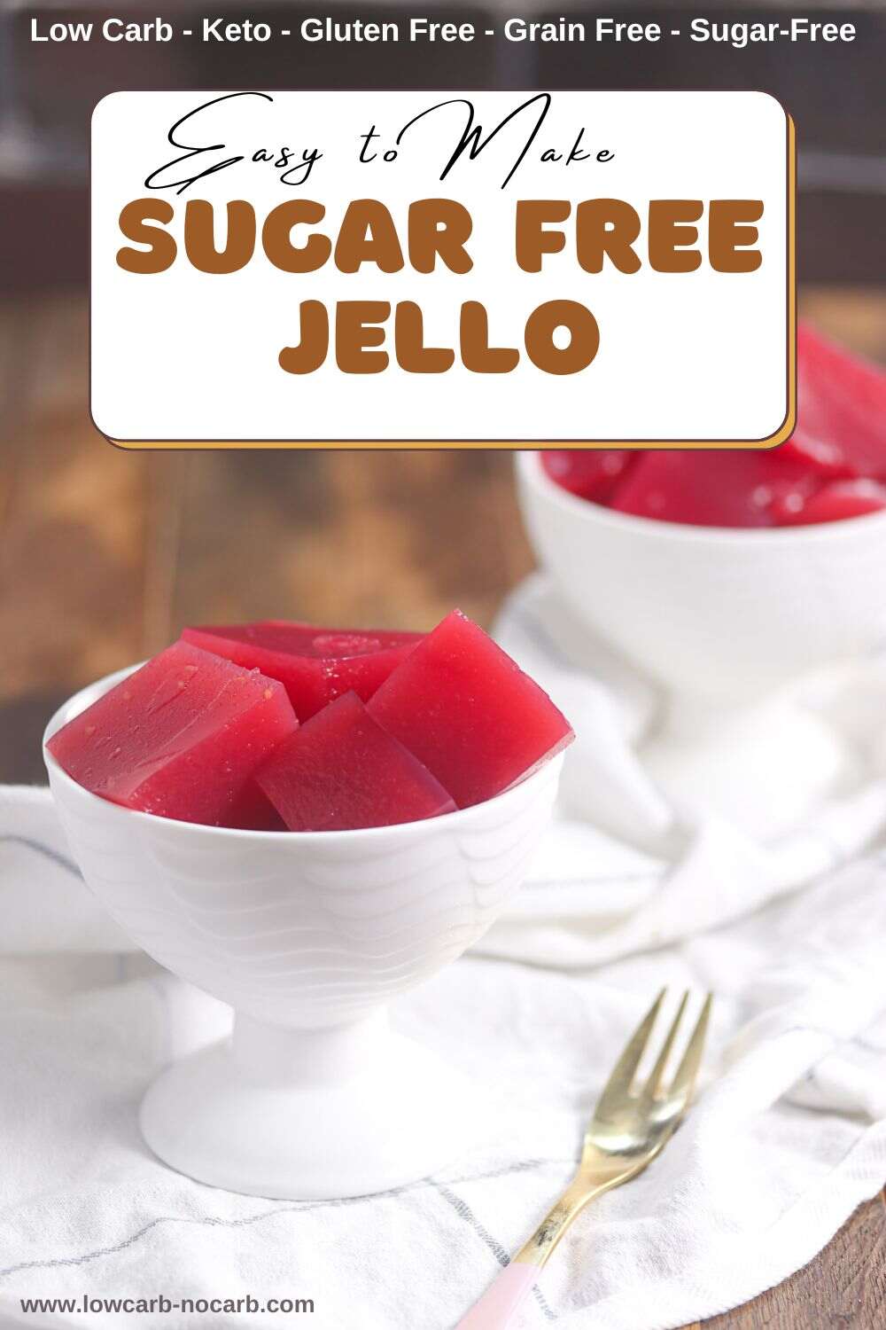Two white bowls filled with red, cubed sugar-free Jello are placed on a white surface with a gold spoon beside one bowl. Text on the image reads "Easy to Make Sugar Free Jello.