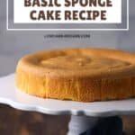 Round sponge cake on a white cake stand, with text indicating it is a basic sponge cake recipe that is keto, low carb, grain-free, and gluten-free.