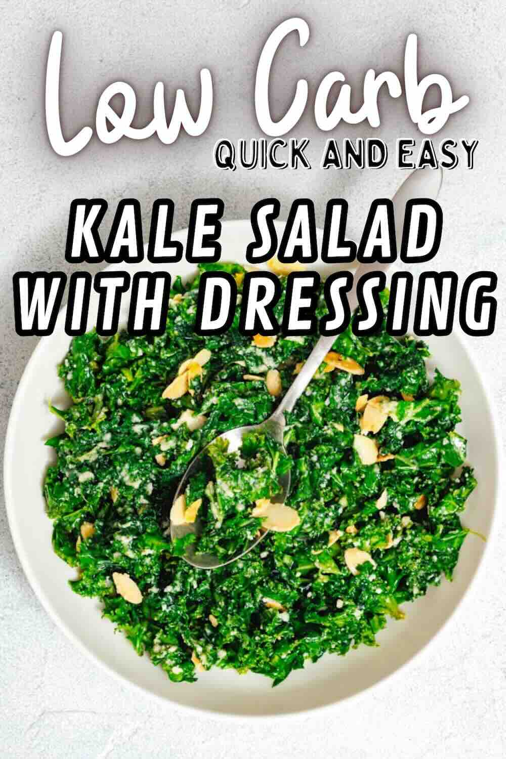 A white bowl filled with chopped kale salad topped with dressing and sliced almonds, with a spoon resting inside. Text on image reads “Low Carb Quick and Easy Kale Salad With Dressing.”.